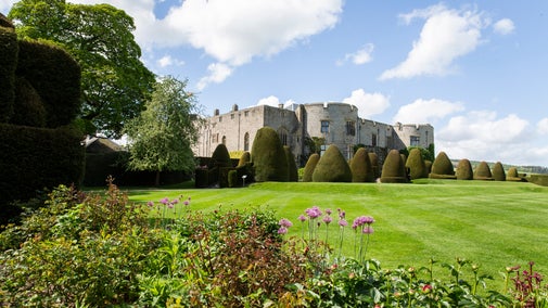 A view of the castle through a blooming garden during spring time.